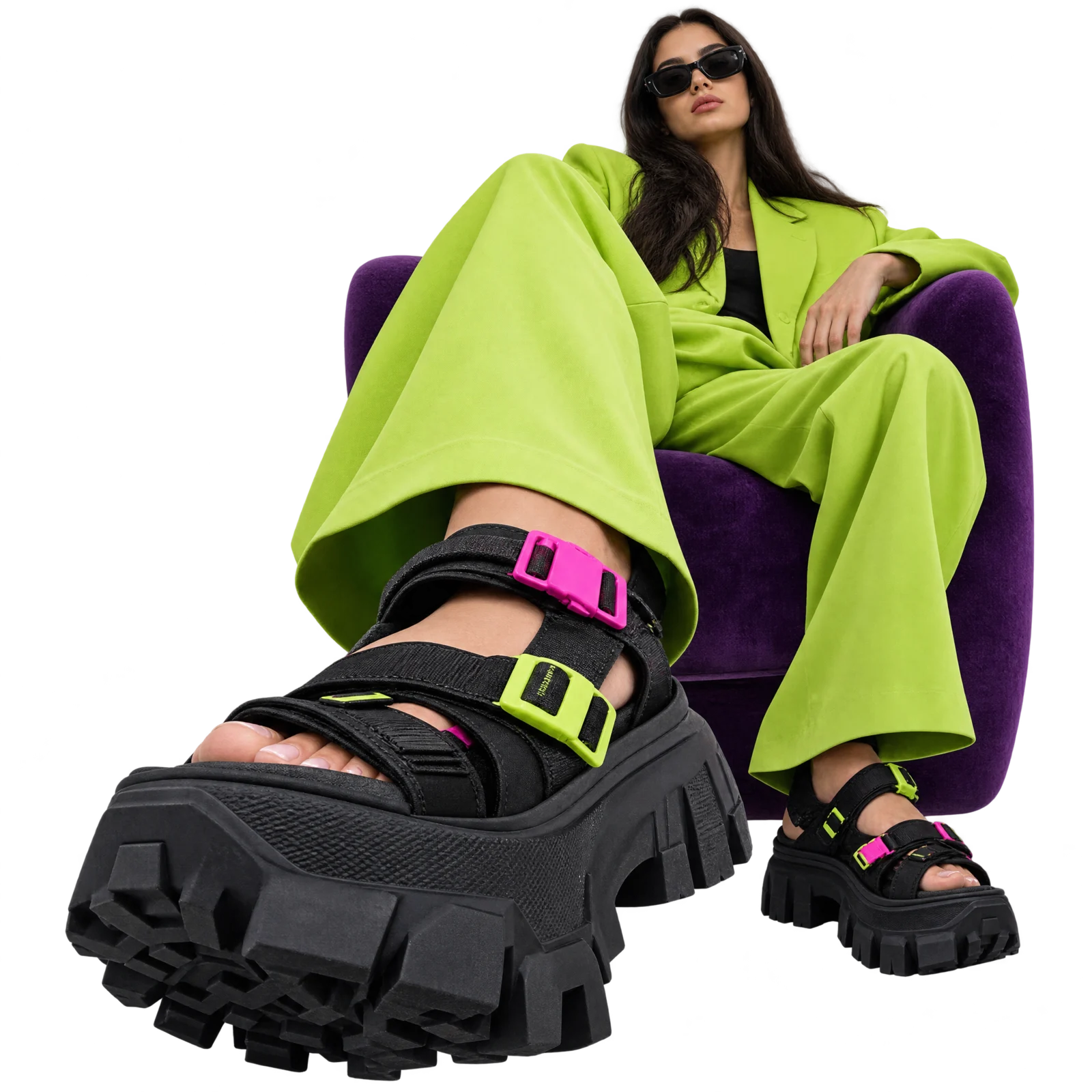 Model in a lime suit wearing black Trail Riot sandals